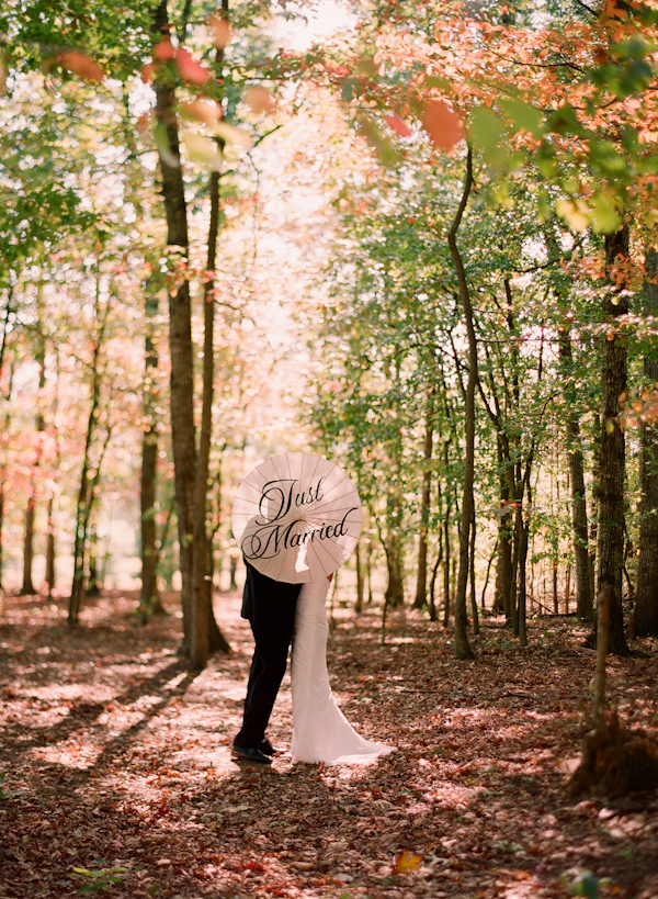 bride and groom with parasol wedding photo by Elizabeth Messina Photography